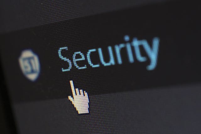 A close-up of a computer screen showing a cursor pointing the word "security".