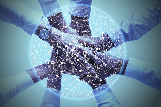 Multiple hands stacked together with an overlay of a digital network globe, symbolizing teamwork, global collaboration, and interconnectedness.