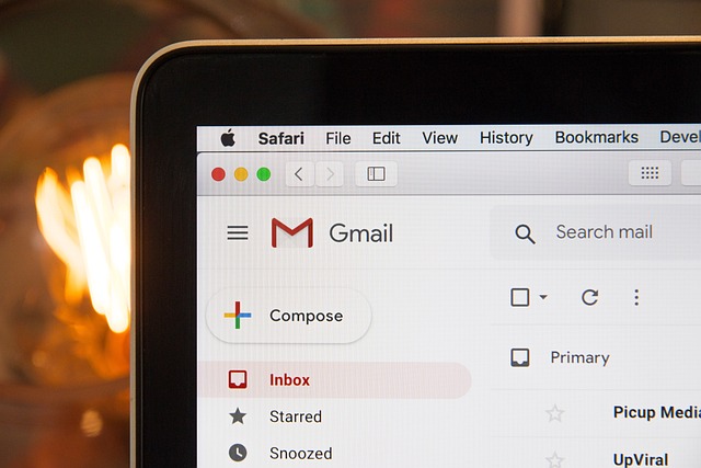 A close-up of the Gmail interface open on a Safari browser, highlighting the inbox and compose options.