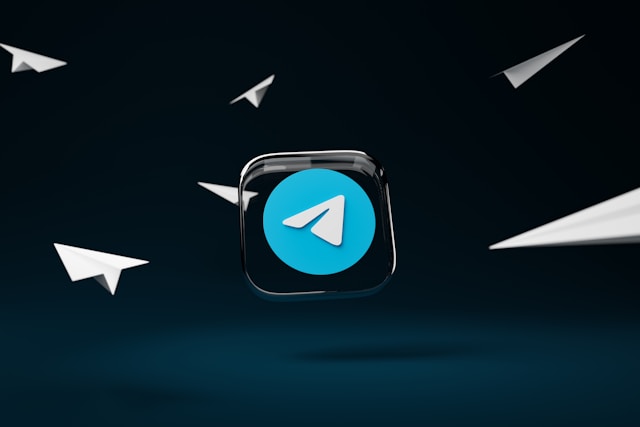 The Telegram logo surrounded by paper planes, symbolizing instant messaging, secure communication, and fast file sharing.