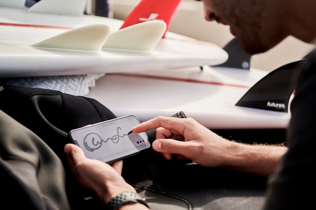 A person signing a digital document on a smartphone, representing electronic signatures and remote agreements.